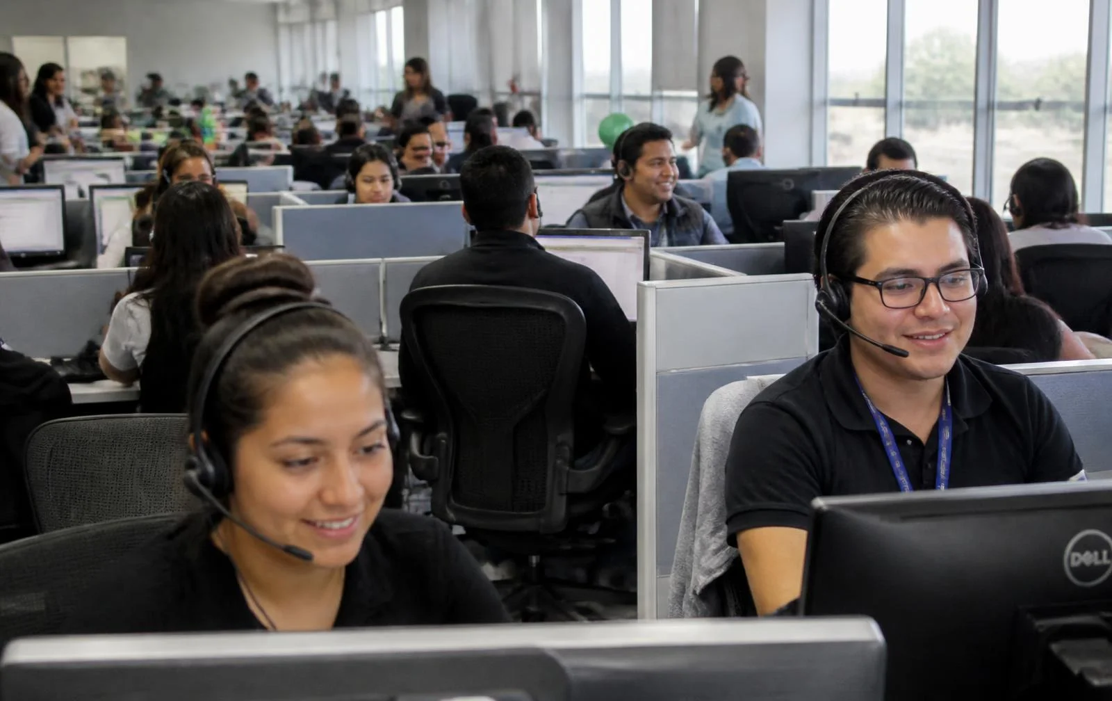 Call center agents from Mexico working with headsets on a modern operations floor